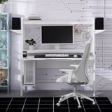 White gaming desk with monitor, keyboard, and ergonomic chair. Shelf for small items, desk supports large monitor, chair fits under desk.