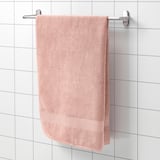 A FREDRIKSJÖN towel on silver rack, light pink, cotton, absorbent with woven border.