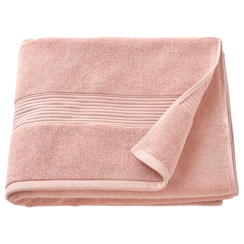 A folded, light pink FREDRIKSJÖN towel made from 100% cotton, featuring a textured pattern and decorative woven border. Perfect for bath use.
