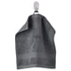 A hanging dark green FREDRIKSJÖN towel made of cotton. It is thick, textured, and a woven border design at the edges.