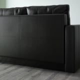 Black leather-look corner sofa with one seat cushion and backrest visible, part of the FRIHETEN convertible series.