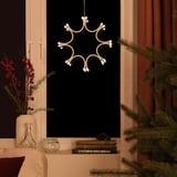 Modern indoor pendant lamp hangs like a snowflake, emitting warm white light, enhancing cozy ambiance.