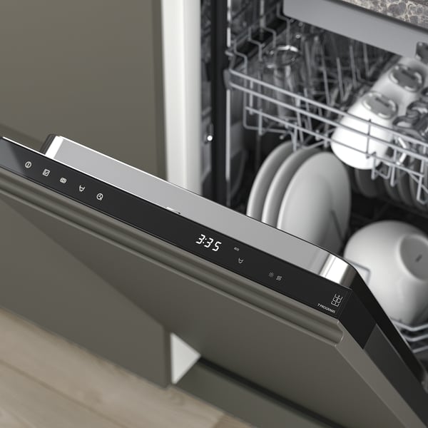 Modern dishwasher showing digital display 3:35 and open racks with clean dishes.