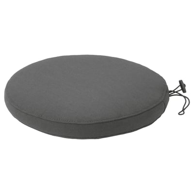 Round grey FRÖSÖN outdoor cushion with black edge, made from recycled materials, featuring a zipper and secure elastic strap.