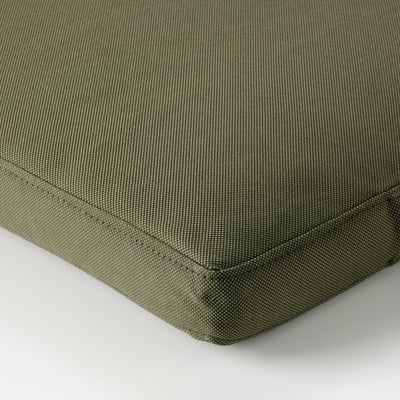 Green outdoor cushion with textured, woven pattern and neat stitching.