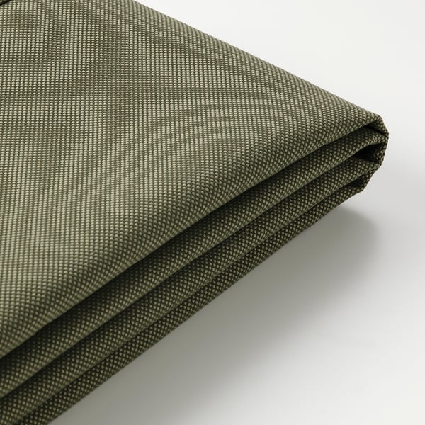 Close-up of green, textured, water-repellent patio cushion cover with zipper.