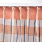 Orange, blue, and white plaid curtains filter light, providing privacy. Hooks and heading tape facilitate easy hanging.