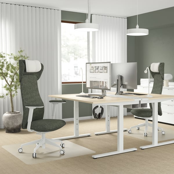 Modern office with GRÖNFJÄLL chairs, dual monitors, natural light, and plant.