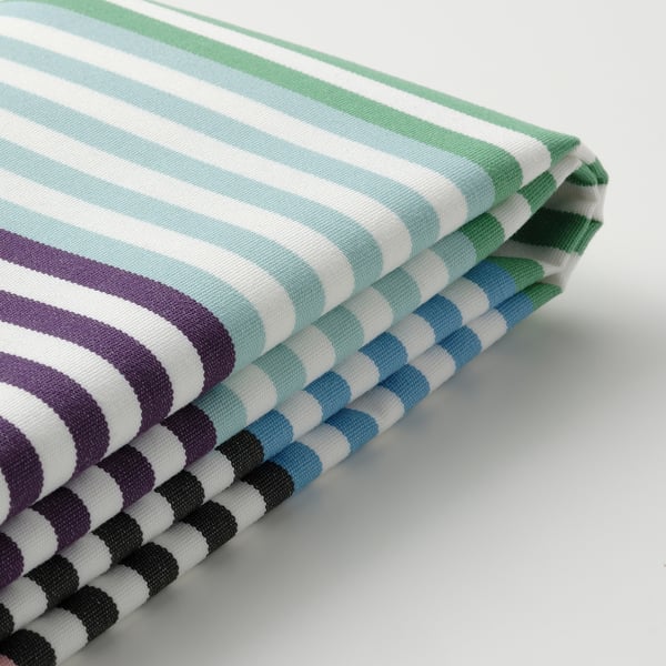 Stacked striped cushions, vibrant colors, crisp texture, outdoor fabric.