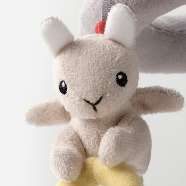 Stuffed animal toy, beige with yellow base, large white ears, black eyes and smile; soft, plush quality.