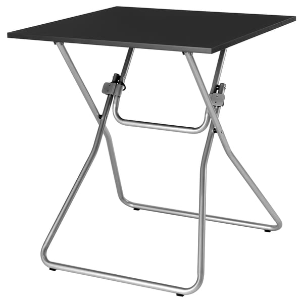GUNDE: black square table with silver metal foldable legs. Modern, minimalist design for easy storage.