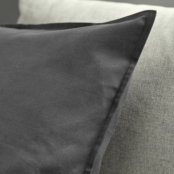 Dark gray cushion cover, well-made, with a concealed zipper, displayed on a light-colored surface.