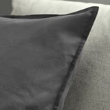 Dark gray cushion cover, well-made, with a concealed zipper, displayed on a light-colored surface.