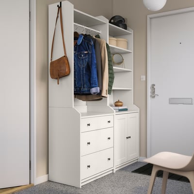 White HAUGA storage unit with open and closed storage, mixing shelves and drawers, perfect for a modern entryway.