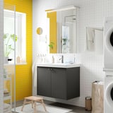 Modern bathroom with grey HAVBÄCK cabinet, white sink, mirror, yellow tiles, wood stool.