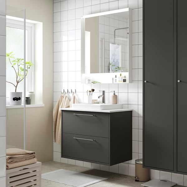 Modern bathroom with grey HAVBÄCK vanity, two drawers, white sink, large mirror, minimalist design.