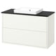 A white HAVBÄCK bathroom vanity with a black countertop and a square ceramic basin. It two drawers and modern, clean lines.