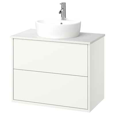White wall-mounted bathroom vanity with round sink and undermount drawers.