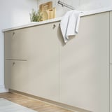 HAVSTORP beige kitchen cabinets with sleek design and ample storage.