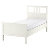 White HEMNES bed, solid pine, rectangular, simple design.
