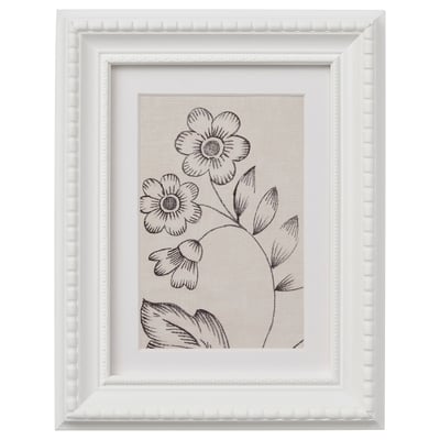 This describes a white framed picture with a black-and-white floral design.