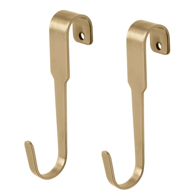 Gold-colored metal wall hooks, simple design, used for hanging items.