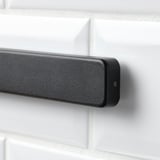 Modern knife rack on tiled wall.