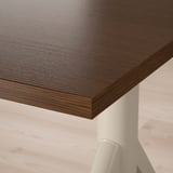 Close-up of smooth, dark wooden tabletop with visible grain texture and rounded edges.