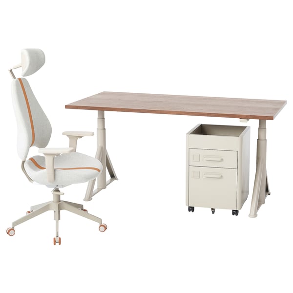 An IDÅSEN home office setup with a light brown desk, adjustable white office chair with orange accents, and a beige filing cabinet on wheels.