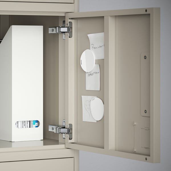 Open desk cabinet with memos and a box inside; metal surface doubles as a magnet board.