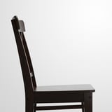 Dark wooden chair with sleek design and high back. Crafted with polished finish, emphasizing durability and comfort.