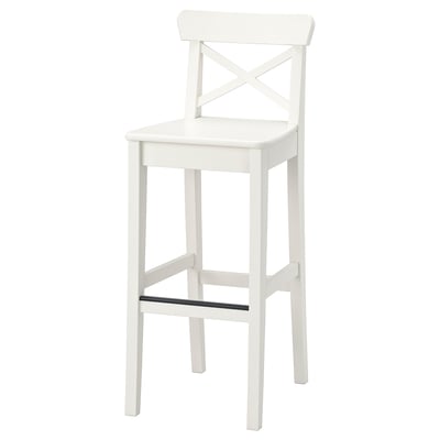 An INGOLF white bar stool with a simple, white, wooden design. It has a backrest with an x shape and a footrest for comfort.