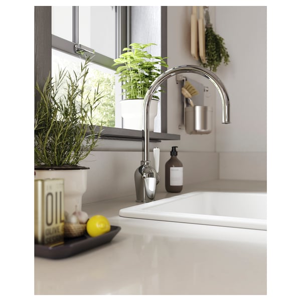 Modern kitchen sink with chrome INSJÖN tap, white basin, green plants, and kitchen accessories.