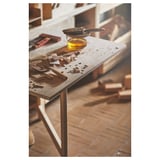 Woodworking station with tools and oil on a table.