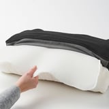 Person touching JÄRPÖN/DUVHOLMEN back cushion, demonstrating water-repellent and comfortable fabric, with zipper for easy removal.