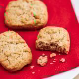 Three KAFFEREP cookies on red material, one partially eaten, showcasing cinnamon and oats texture.