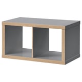 Ikea KALLAX grey shelf unit. Modern rectangular design with open sections, combining grey and wooden materials.