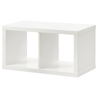 A white KALLAX shelving unit. Its rectangular with open compartments, designed for versatile storage.
