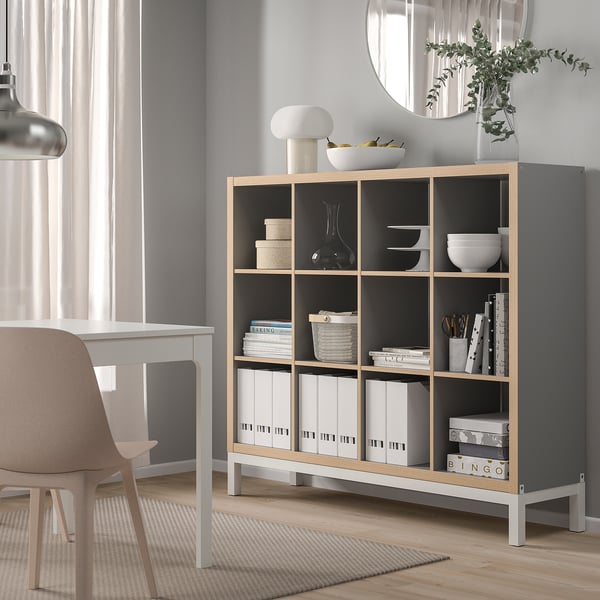 KALLAX shelving unit in gray & oak with books & decor