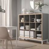 KALLAX shelving unit in gray & oak with books & decor
