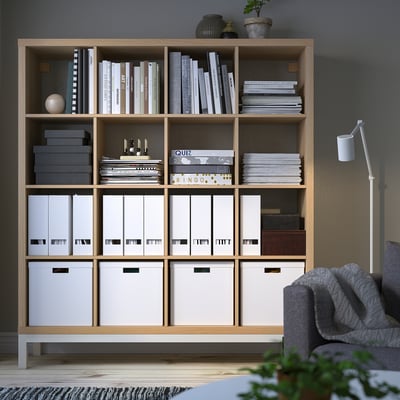 Bookshelf KALLAX: wood, large, cubed shelves. Holds books, bins, plants. Tall, fits room.