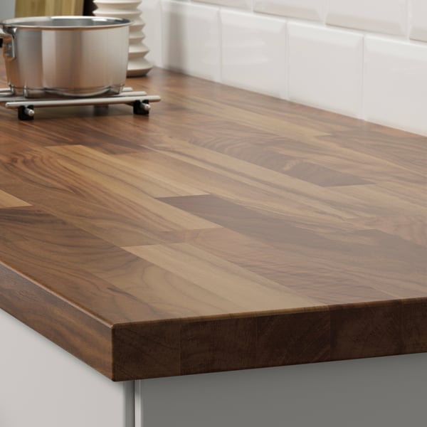 Wooden kitchen countertop with smooth, polished walnut veneer.