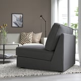 Modern living room featuring a gray KIVIK sofa-bed, ideal for small spaces, positioned near a window.