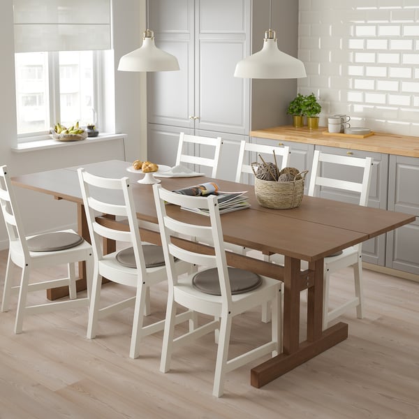 KLIMPFJÄLL dining set with wooden table and six chairs in modern kitchen.