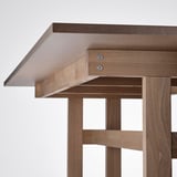 Durable, wooden desk with light finish, sleek drawer, sturdy legs.