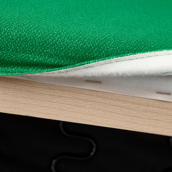Close-up of green fabric on wood furniture with sturdy straps.