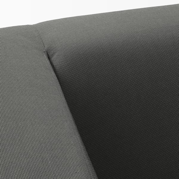 Black fabric upholstery with a subtle tone-on-tone pattern, likely from a sofa, showing a close-up of its smooth, durable texture.