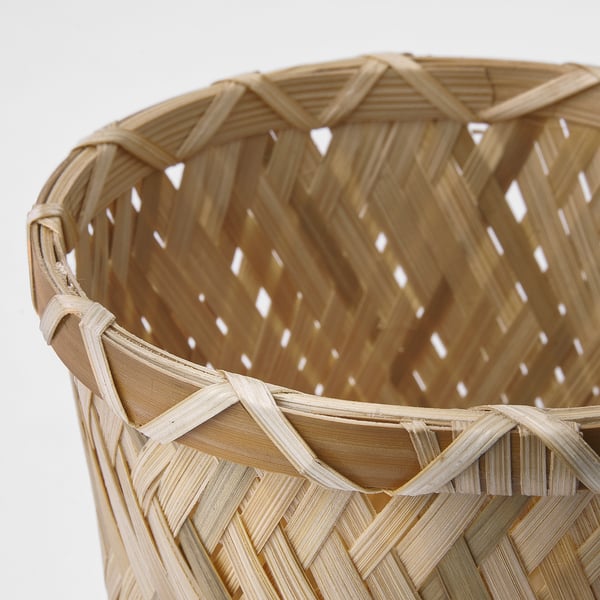 Handwoven bamboo basket with intricate patterns, showcasing high-quality craftsmanship, perfect for home decor.
