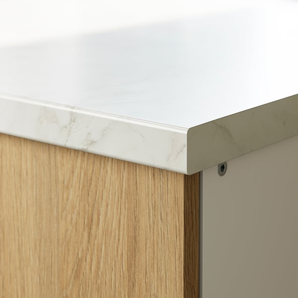 Close-up of sleek kitchen countertop seamlessly meeting wooden cabinet, showcasing modern design.