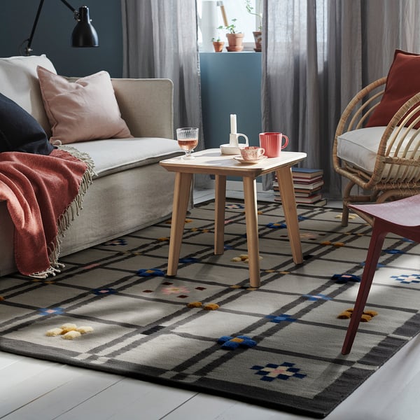 Cozy living room with KNYLHAVREN multicolored rug, traditional/modern mix.
